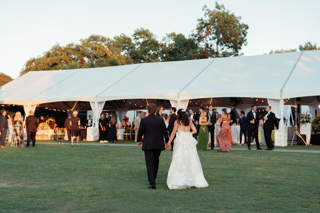 Guests enjoying cocktails under the sunset at a luxury Dallas garden wedding.