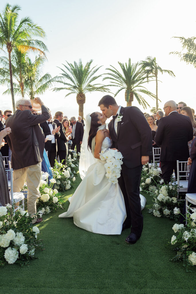 Bride and groom sharing a romantic sunset moment at The St. Regis Longboat Key Resort captured by Megan Kay Photography.