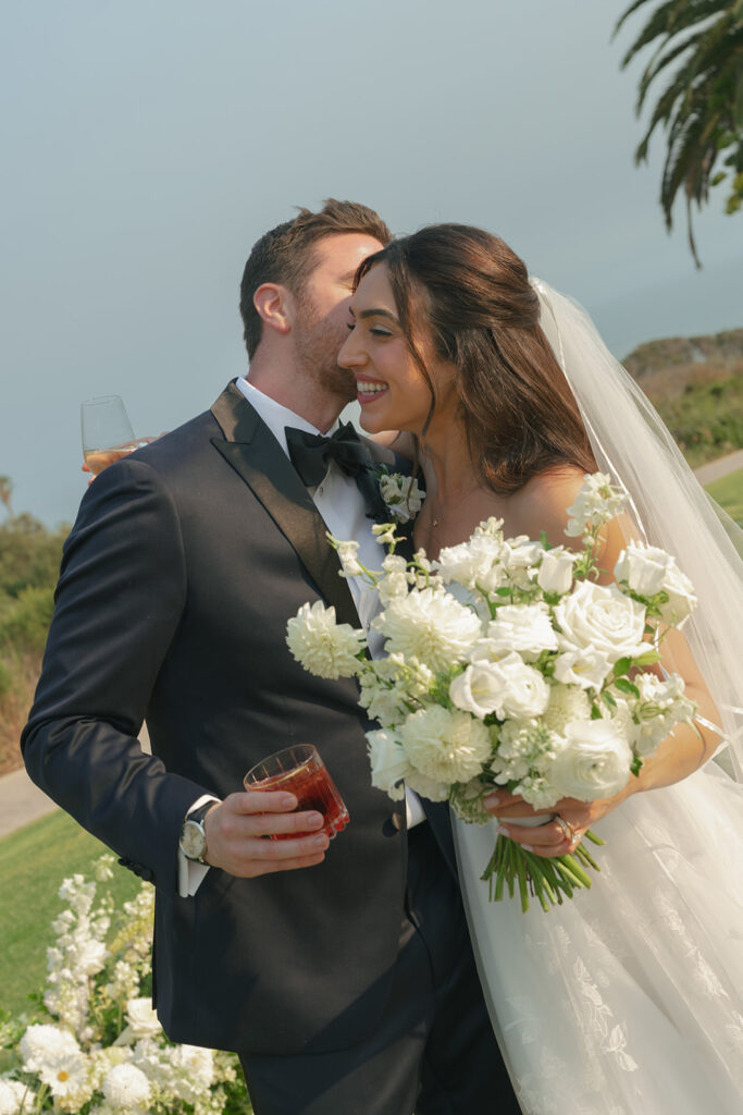 Bride and groom moments after becoming one at The Ritz-Carlton Bacara, surrounded by elegant floral arrangements.