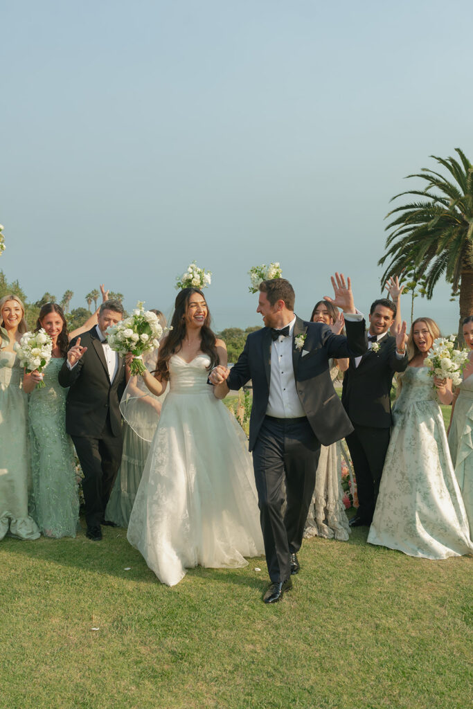 Bride and groom moments after becoming one at The Ritz-Carlton Bacara, surrounded by elegant floral arrangements.