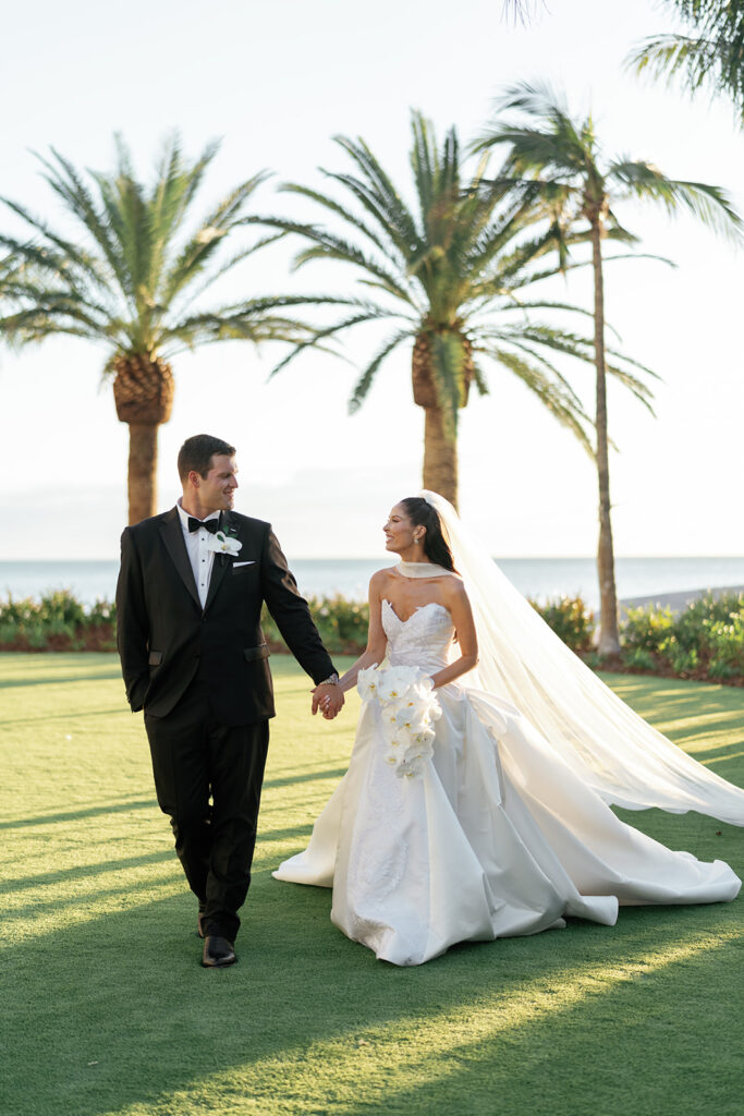 Bride and groom sharing a romantic sunset moment at The St. Regis Longboat Key Resort captured by Megan Kay Photography.