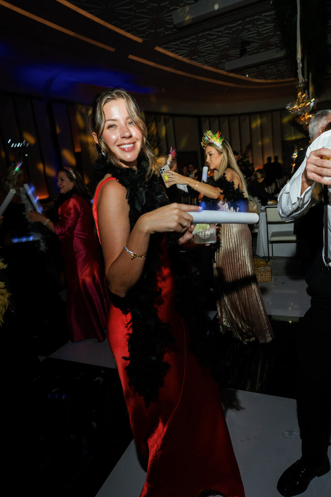 Guests dancing under twinkling lights at The St. Regis Longboat Key wedding reception with luxury décor and joyful energy.