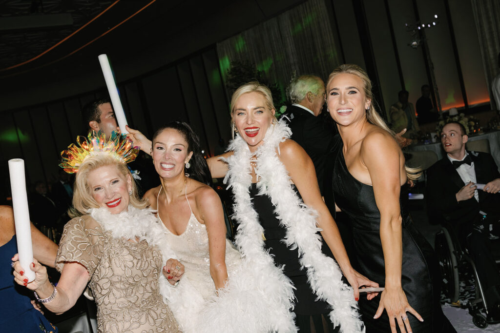 Guests dancing under twinkling lights at The St. Regis Longboat Key wedding reception with luxury décor and joyful energy.