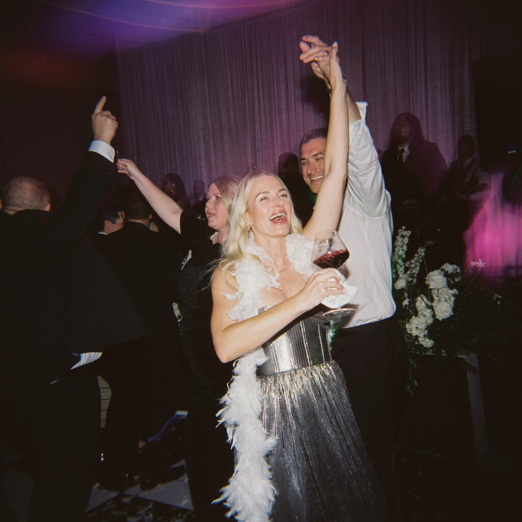 Guests dancing under twinkling lights at The St. Regis Longboat Key wedding reception with luxury décor and joyful energy.