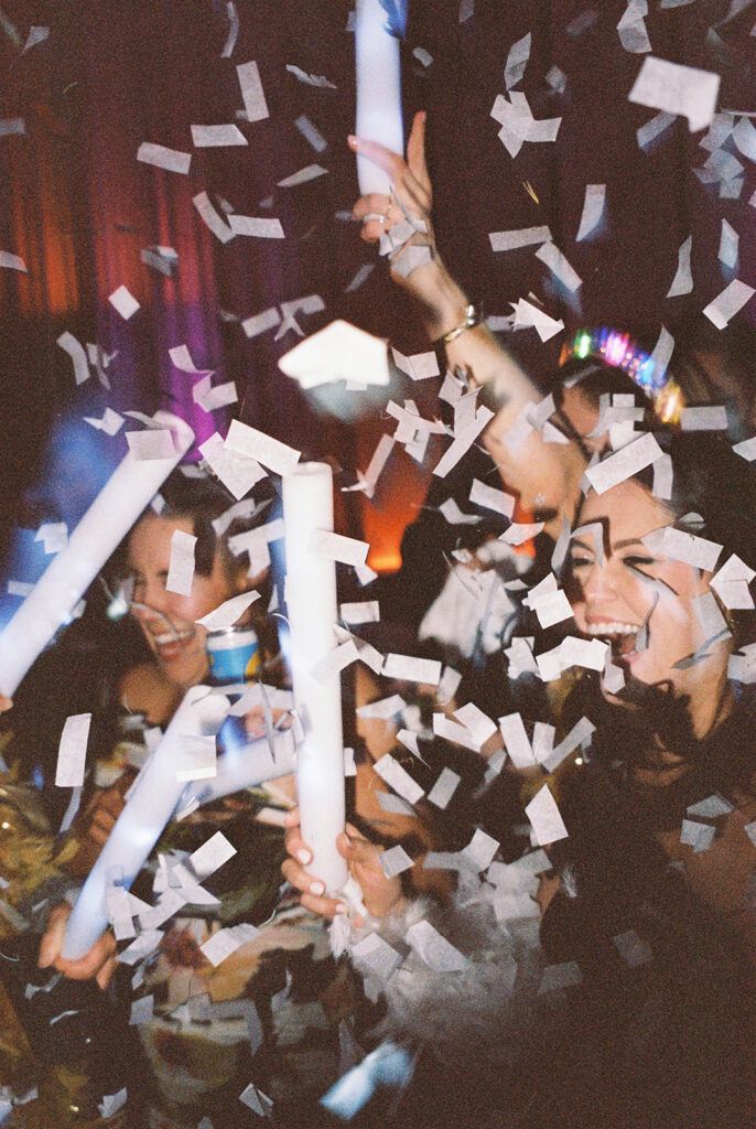 Guests dancing under twinkling lights at The St. Regis Longboat Key wedding reception with luxury décor and joyful energy.