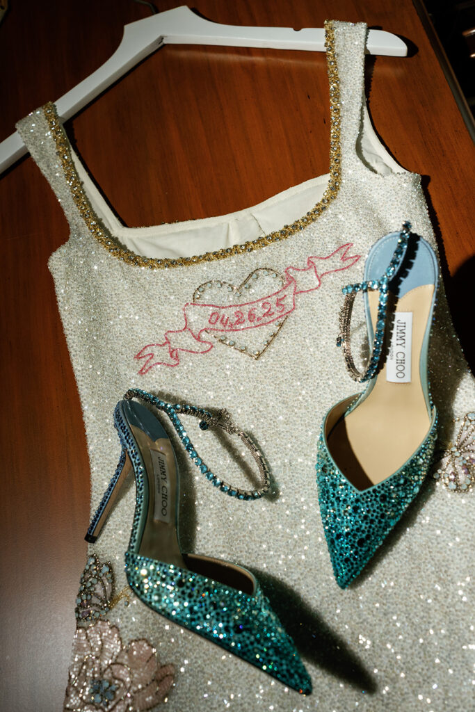 Bride and groom dancing during the wedding after party at a Texas country club, with the bride wearing a custom beaded dress featuring their anniversary on the back