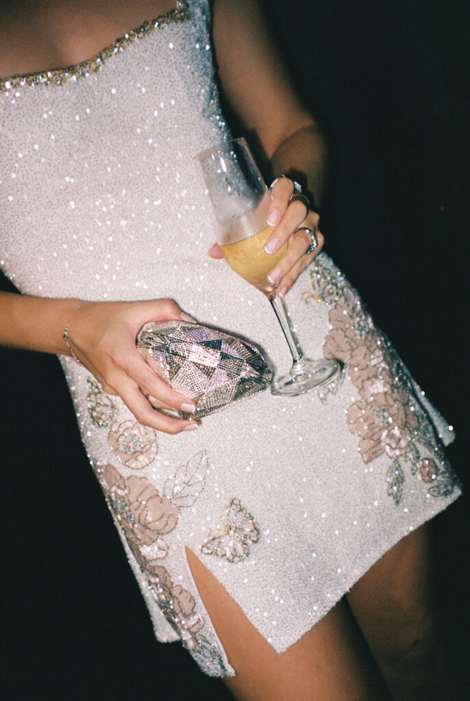 Bride and groom dancing during the wedding after party at a Texas country club, with the bride wearing a custom beaded dress featuring their anniversary on the back